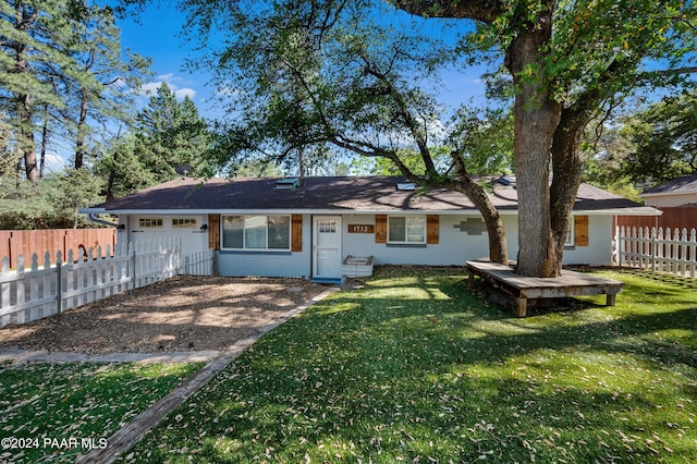 rear view of property with a yard and a garage