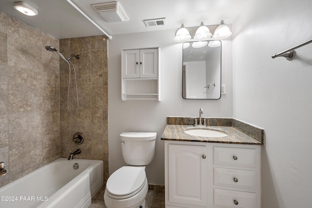 full bathroom featuring tiled shower / bath, tile patterned flooring, vanity, and toilet