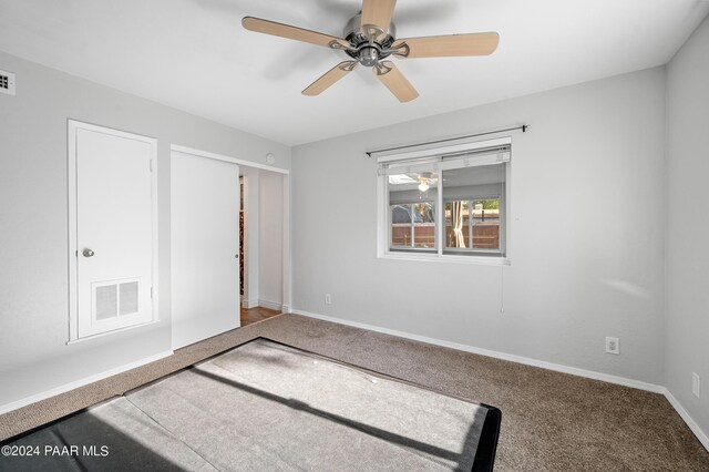 unfurnished bedroom with carpet floors and ceiling fan