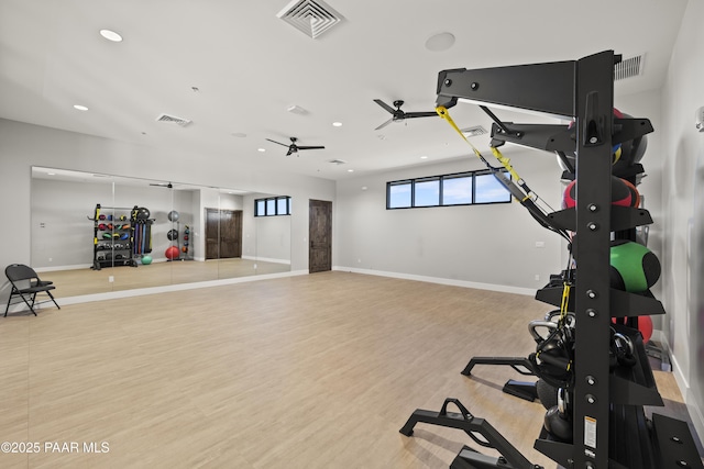 exercise area with recessed lighting, visible vents, light wood-style flooring, and baseboards