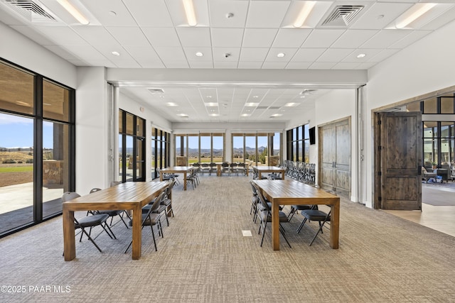 dining area featuring visible vents, a paneled ceiling, and carpet