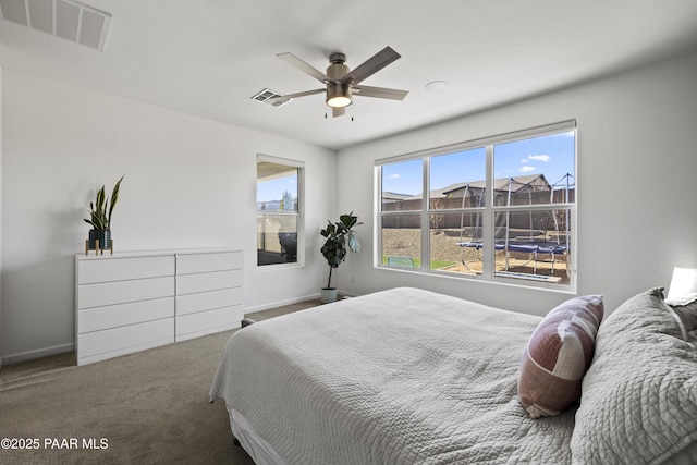 bedroom featuring baseboards, visible vents, a ceiling fan, and carpet