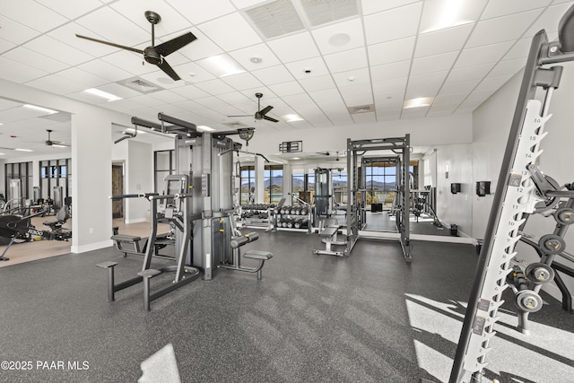 gym with visible vents, baseboards, and ceiling fan