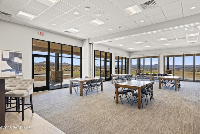 dining room featuring visible vents, plenty of natural light, and a mountain view