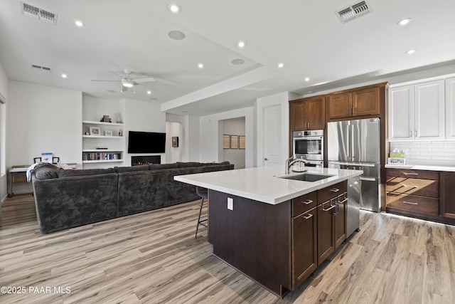 kitchen with visible vents, appliances with stainless steel finishes, and a sink