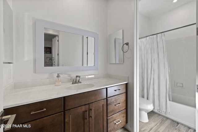 bathroom with vanity, wood finished floors, toilet, and shower / bathtub combination with curtain