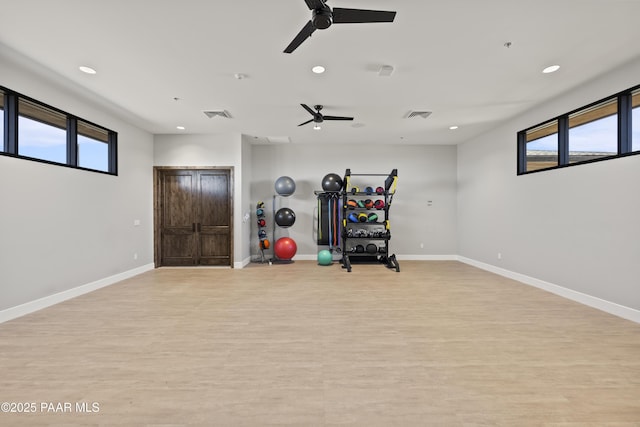 exercise area featuring light wood finished floors, visible vents, recessed lighting, and baseboards