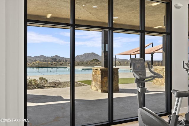 doorway featuring a wall of windows and a mountain view