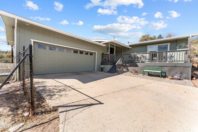 ranch-style home featuring a garage and a deck