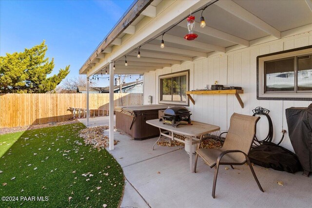 view of patio featuring grilling area and a hot tub