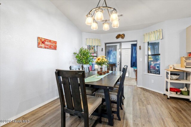 dining room featuring a chandelier and wood-type flooring