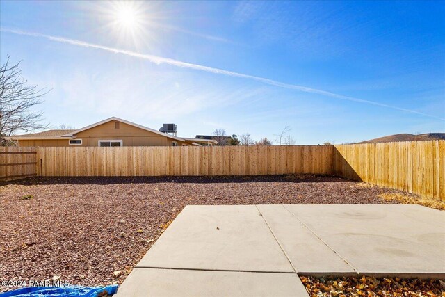 view of yard featuring a patio and central AC