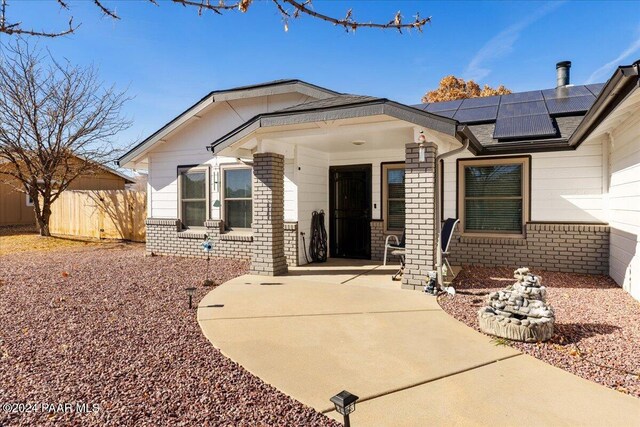 view of front of property featuring solar panels