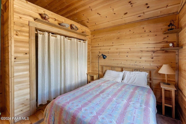 bedroom featuring wooden walls, wood ceiling, and hardwood / wood-style flooring