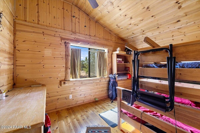 unfurnished bedroom with wood ceiling, wood walls, light hardwood / wood-style floors, and lofted ceiling