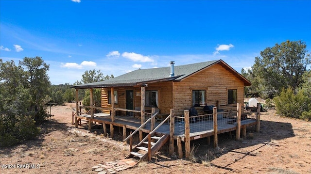 back of property featuring a deck