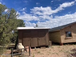 view of home's exterior with an outbuilding