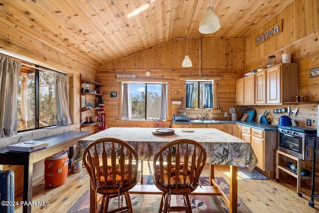 dining room with light hardwood / wood-style floors, vaulted ceiling, wooden ceiling, and sink