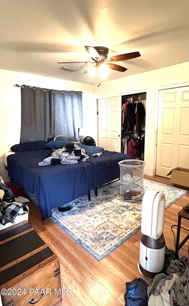 bedroom with ceiling fan and wood-type flooring