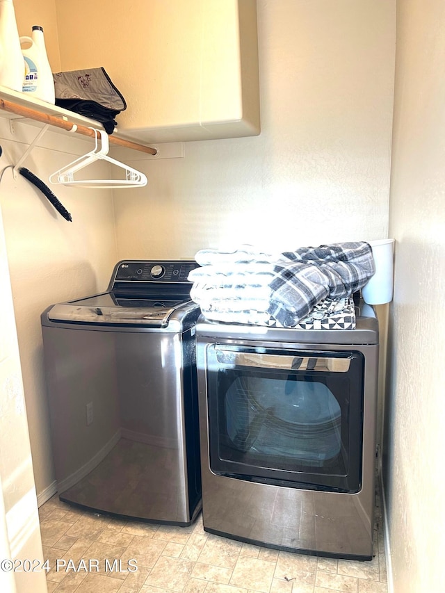 clothes washing area with separate washer and dryer