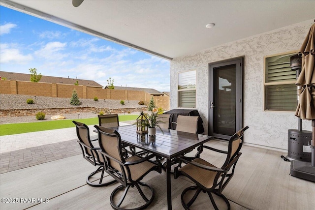 view of patio with outdoor dining area and a fenced backyard
