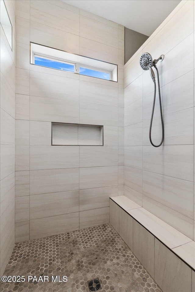 full bath featuring tiled shower