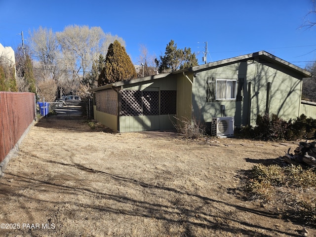 view of side of property with ac unit