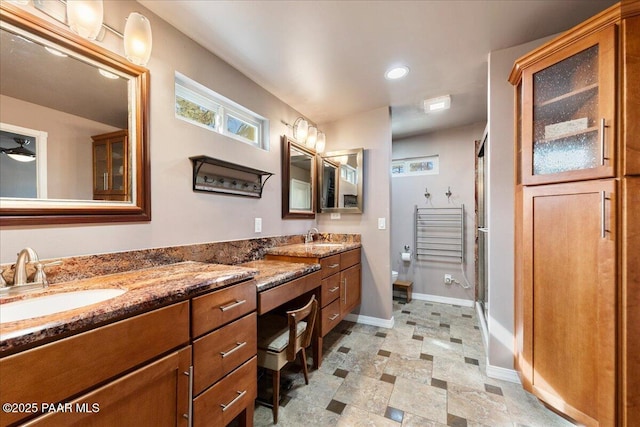 bathroom featuring vanity, toilet, and an enclosed shower