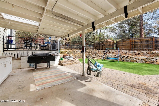 view of patio featuring a grill and a trampoline