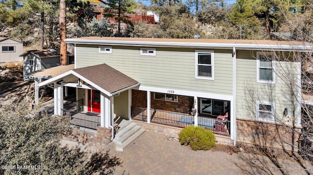 rear view of property with covered porch