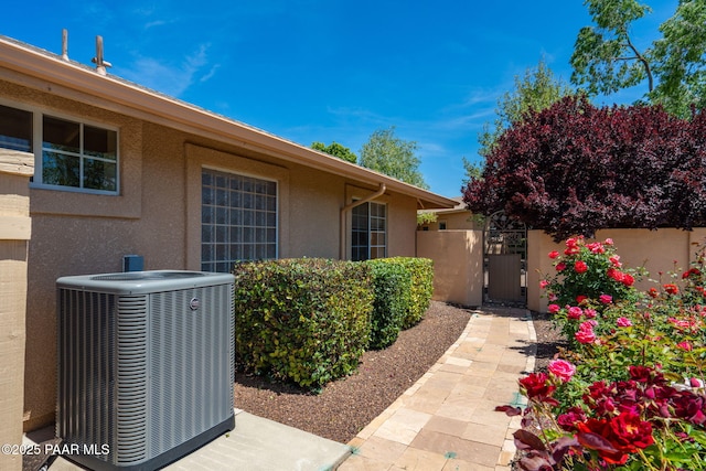 920 Heather Ln, Chino Valley, AZ 86323 - view of exterior entry with cooling unit, stucco siding, and a gate