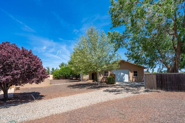 920 Heather Ln, Chino Valley, AZ 86323 - view of front of home featuring gravel driveway, a garage, and stucco siding
