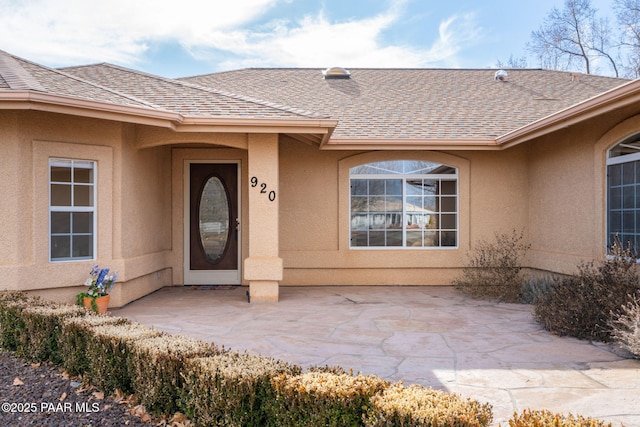 920 Heather Ln, Chino Valley, AZ 86323 - property entrance with stucco siding, a shingled roof, and a patio area