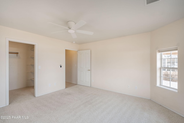 920 Heather Ln, Chino Valley, AZ 86323 - unfurnished bedroom featuring light carpet, a walk in closet, baseboards, and ceiling fan