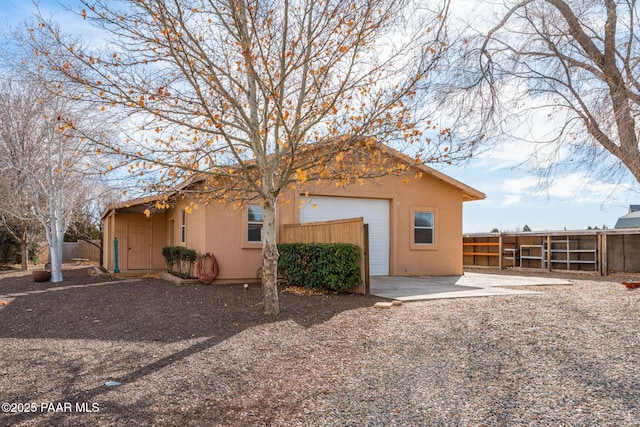 920 Heather Ln, Chino Valley, AZ 86323 - view of home's exterior with stucco siding, a fenced backyard, and an attached garage