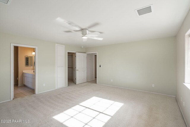 920 Heather Ln, Chino Valley, AZ 86323 - unfurnished bedroom featuring light colored carpet, baseboards, connected bathroom, and a ceiling fan