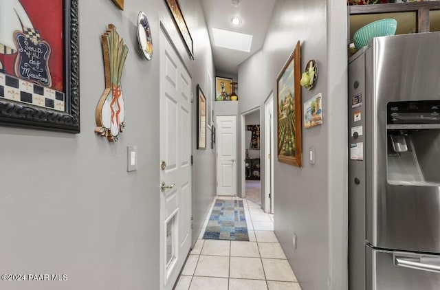 hall featuring light tile patterned flooring