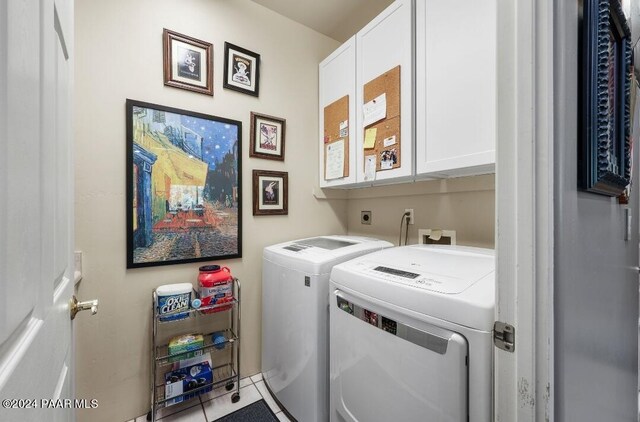 laundry room with cabinets, separate washer and dryer, and tile patterned floors