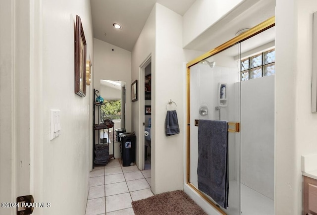 bathroom with vanity, tile patterned floors, and a shower with door