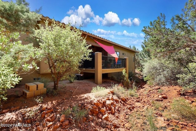 view of property exterior with a wooden deck