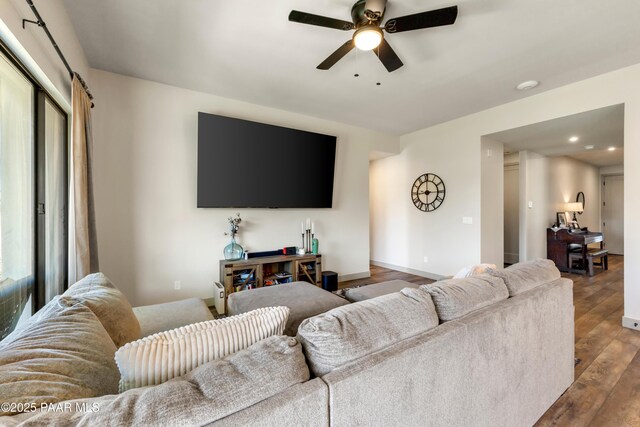 living room featuring hardwood / wood-style floors and ceiling fan