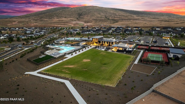 aerial view at dusk featuring a mountain view