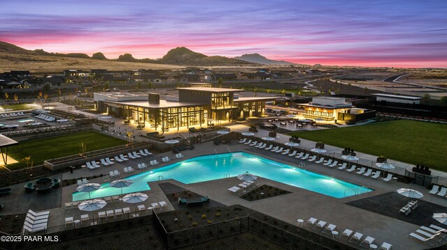 pool at dusk featuring a mountain view