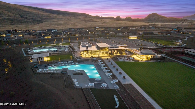 pool at dusk featuring a mountain view