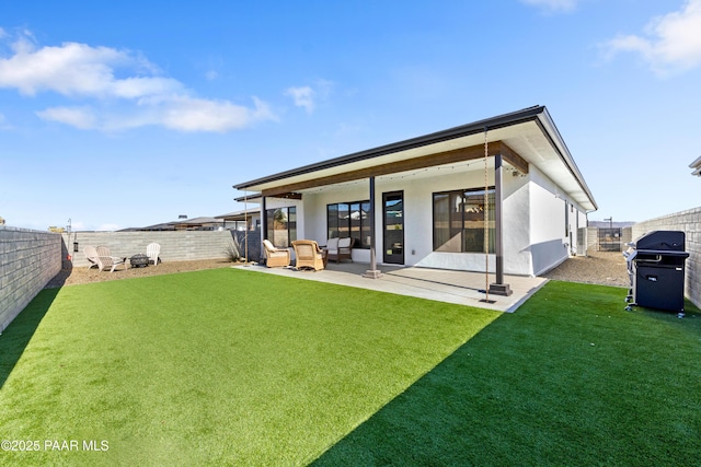 back of house with a patio and a lawn