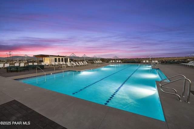 view of pool at dusk