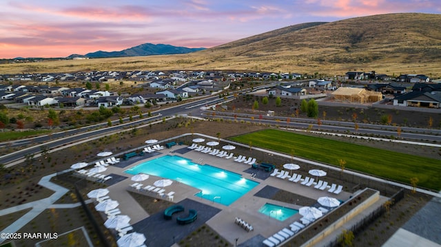 aerial view at dusk featuring a mountain view