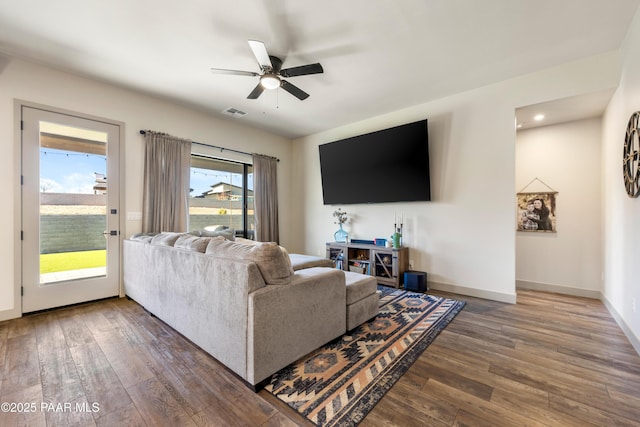 living room featuring hardwood / wood-style flooring and ceiling fan