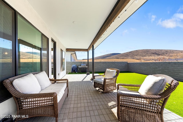 view of patio featuring an outdoor living space and a mountain view