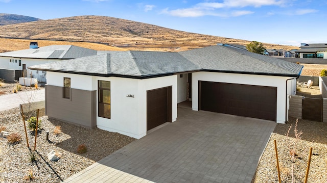 view of front of house with a garage and a mountain view